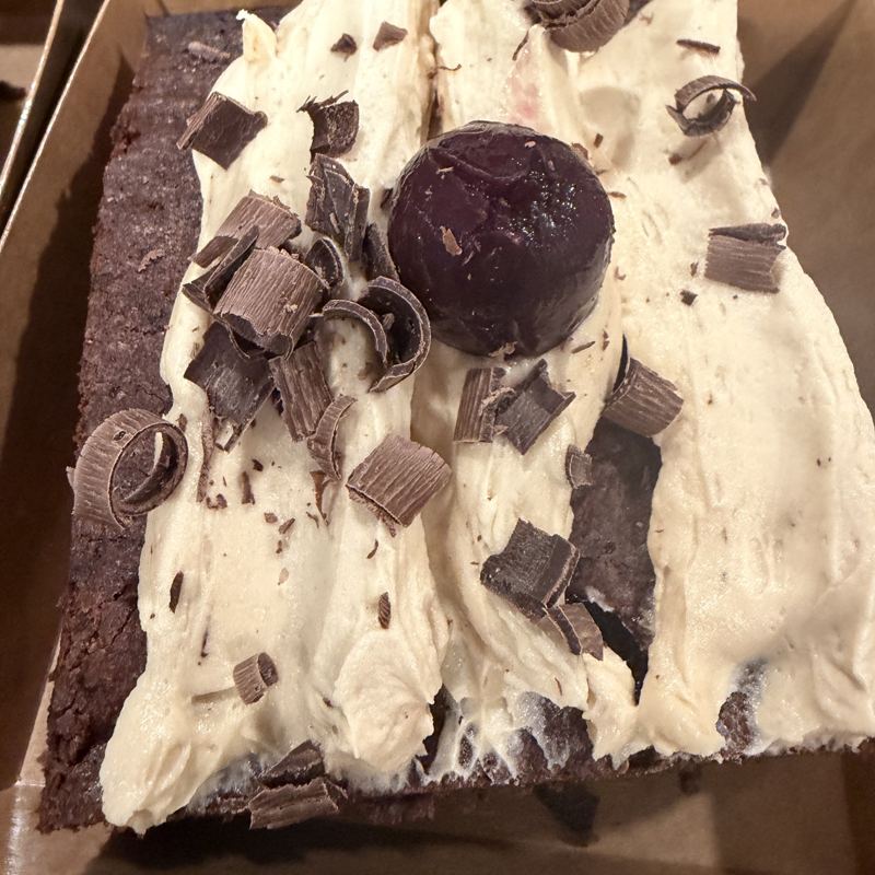 Frosted brownie topped with chocolate curls